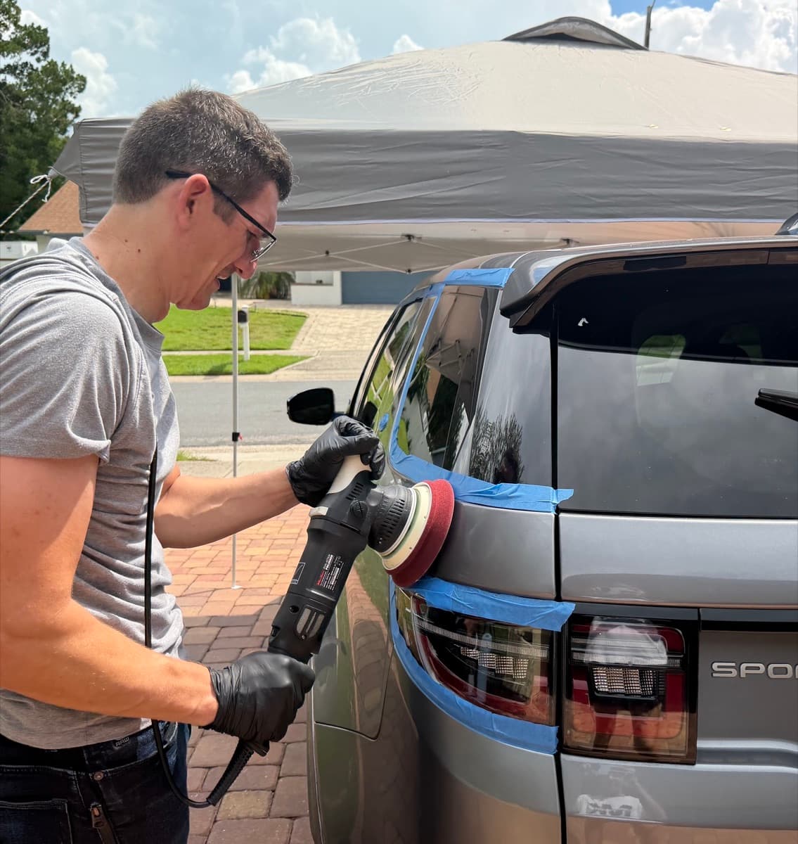 Pavlo, founder of DVP Paint Correction, polishing a vehicle